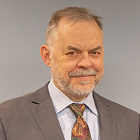 Steve is of fair complexion with short brownish gray hair.