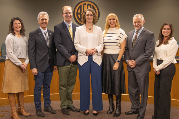 City Council standing in front of the dieses in Council Cahmbers.