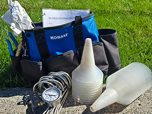 Blue bag with various equipment inside of it.