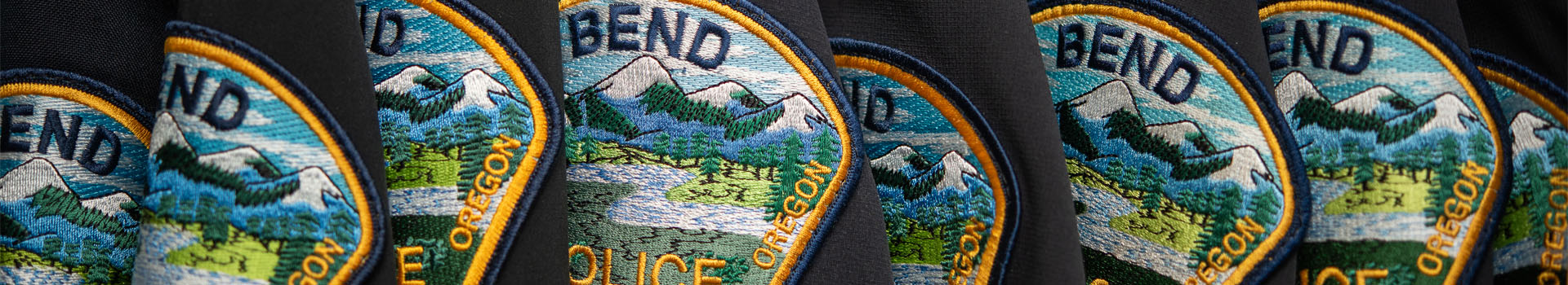 Police patches on sleeves of uniforms.